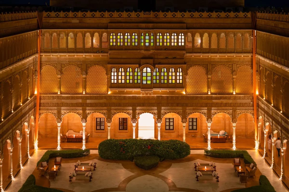 Illuminated Rajasthan palace courtyard at night prepared for an elegant celebration